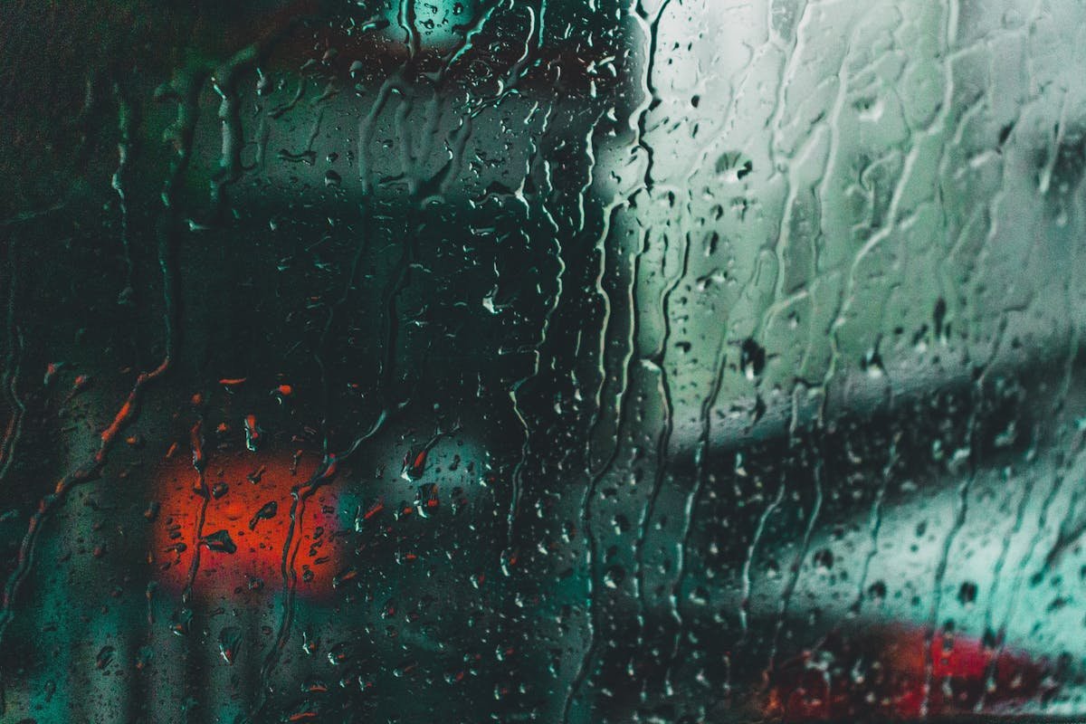 Water droplets on a dirty window glass surface