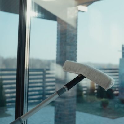 Water-fed pole brush head pressed against a clean glass window for purified water window cleaning