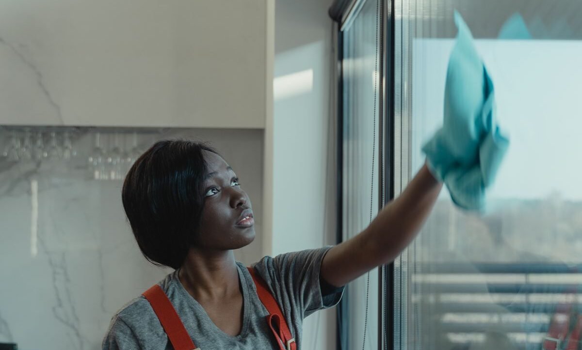 Professional window washing in Chicago — cleaner wiping a large glass panel