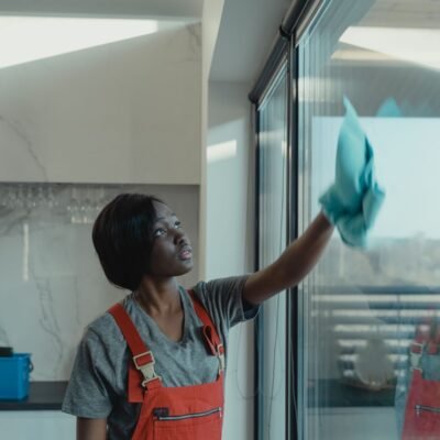 Professional window washing in Chicago — cleaner wiping a large glass panel