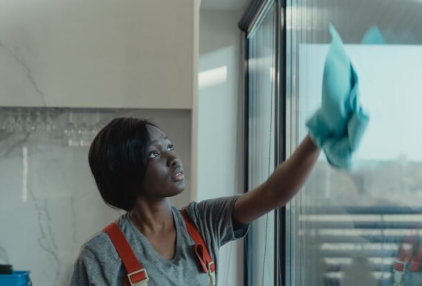 Professional window washing in Chicago — cleaner wiping a large glass panel