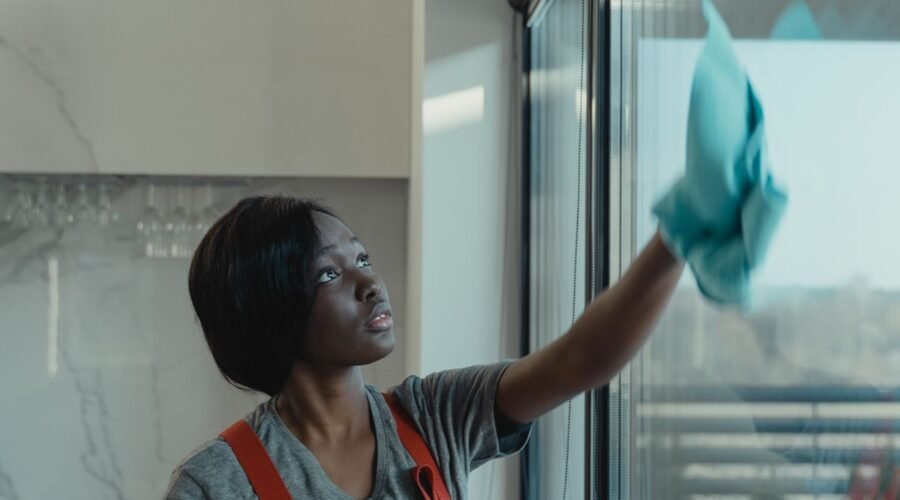 Professional window washing in Chicago — cleaner wiping a large glass panel