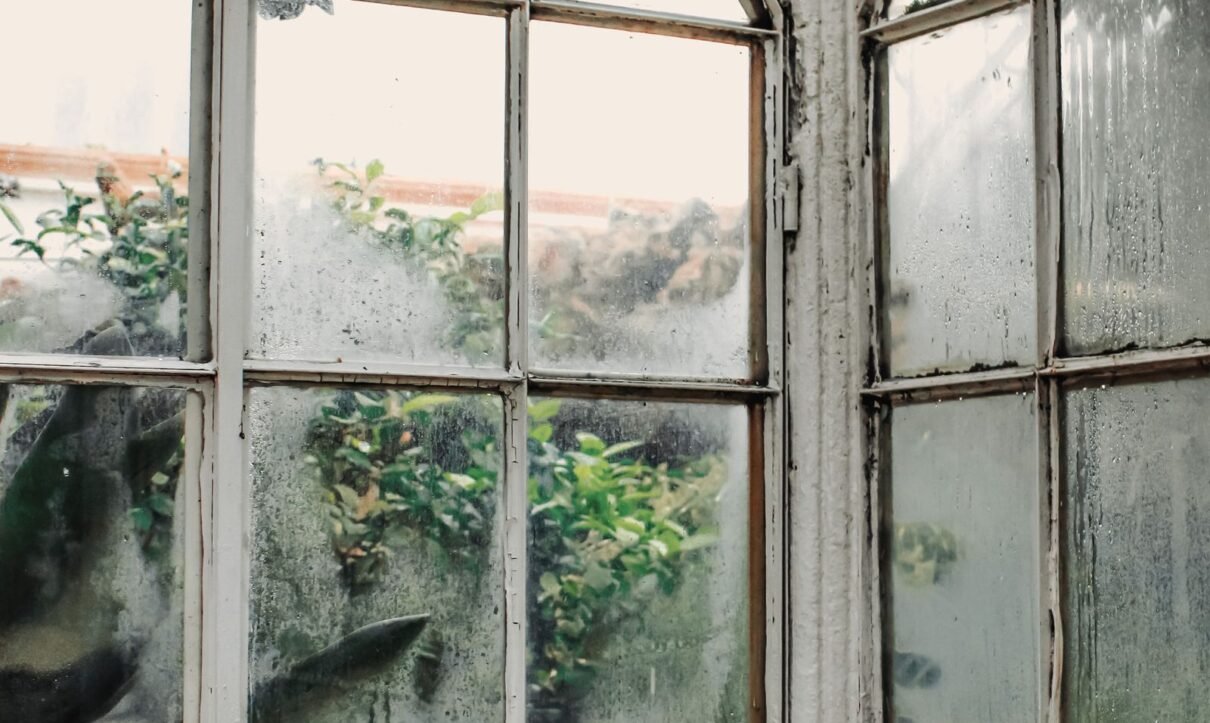 Hazy, cloudy glass panes on old arched windows