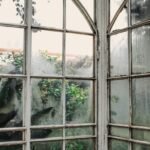 Hazy, cloudy glass panes on old arched windows