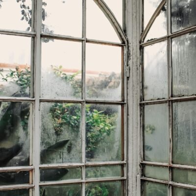 Hazy, cloudy glass panes on old arched windows
