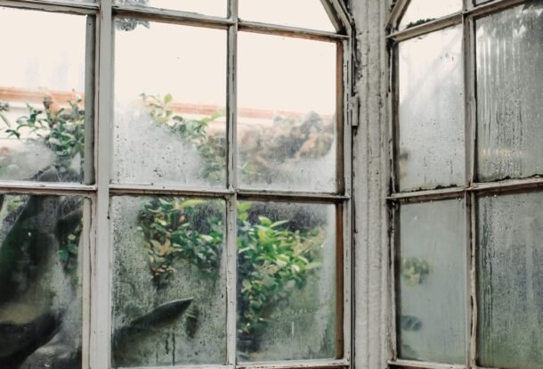 Hazy, cloudy glass panes on old arched windows