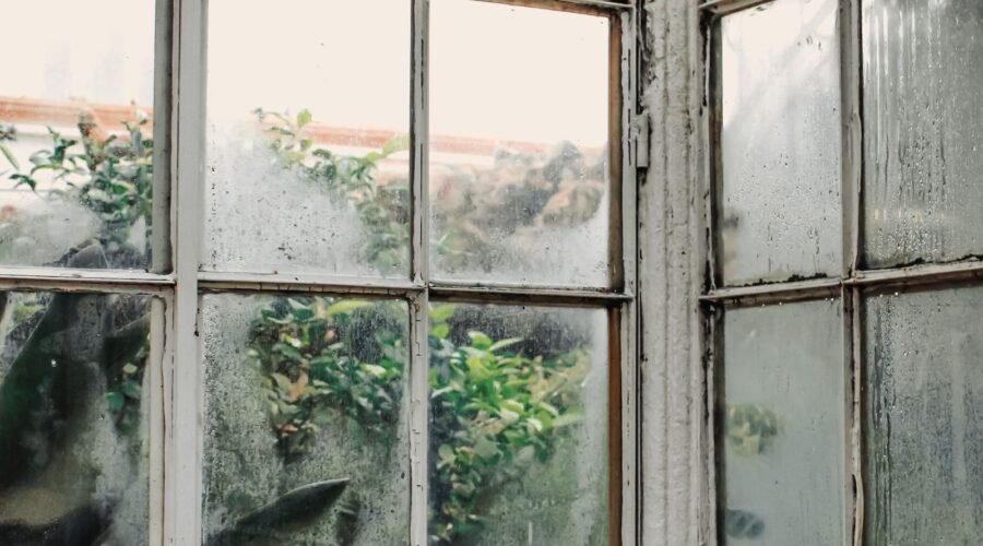 Hazy, cloudy glass panes on old arched windows
