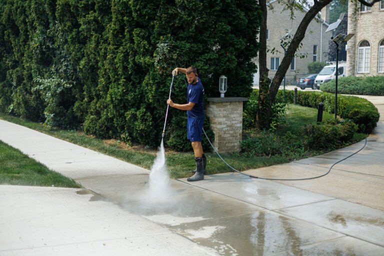 Ernest Windows technician power washing a sidewalk in the Chicago suburbs
